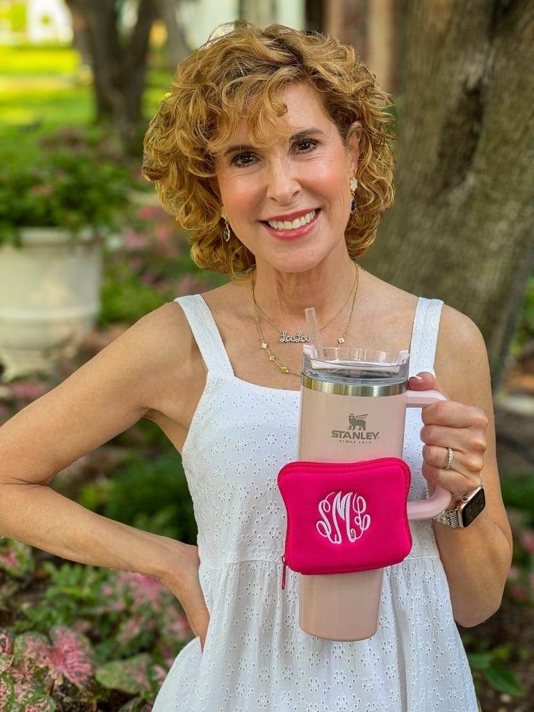 woman wearing white dress holding a pink stanley cup with a hot pink cup belt bag from Marley Lilly