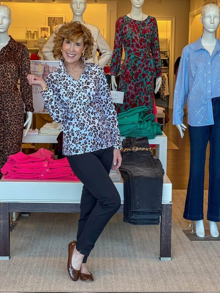 woman over 50 standing in a talbots store wearing on of the 2024 fall trends