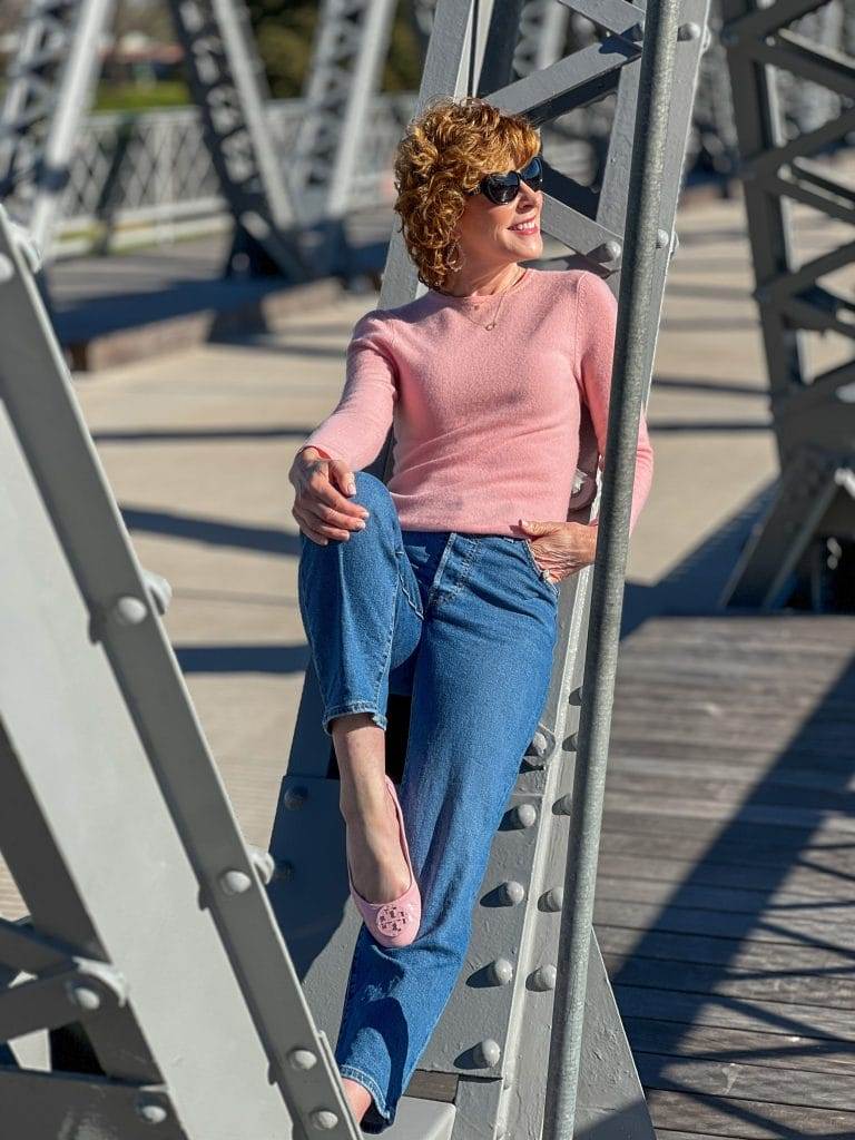 woman wearing pink sweater on the waco suspension bridge