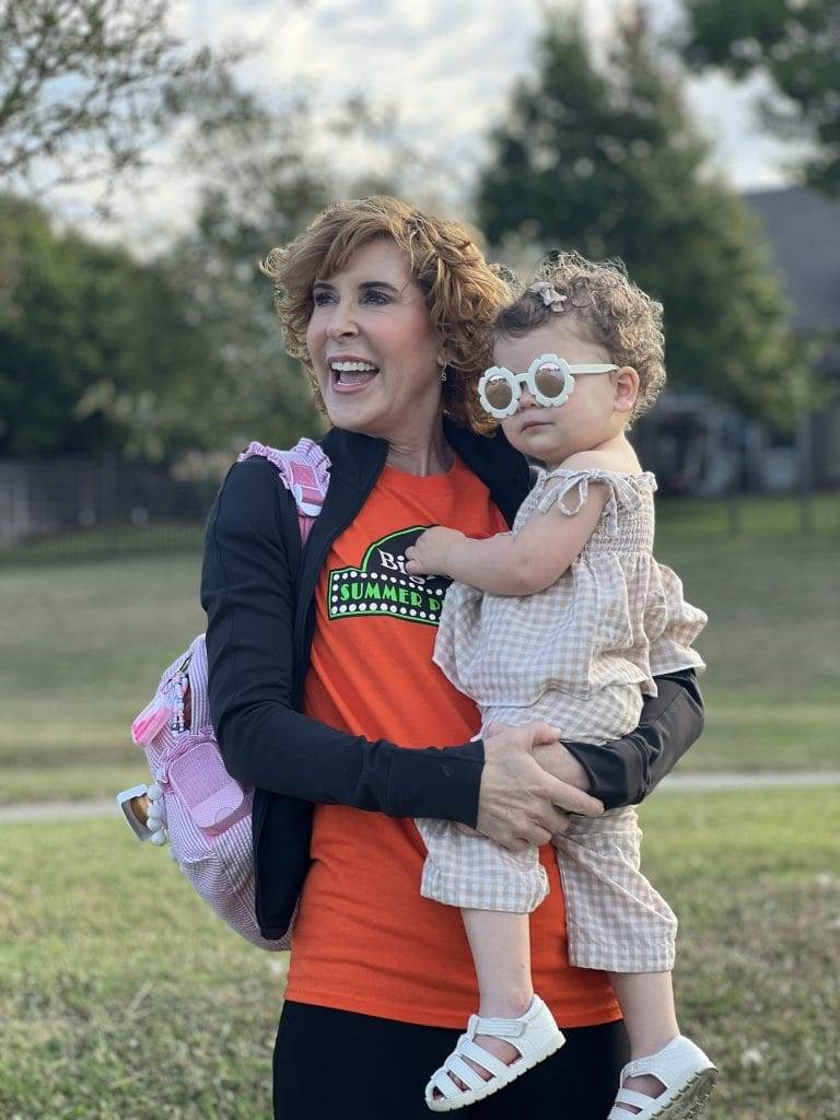 woman holding a baby in a park