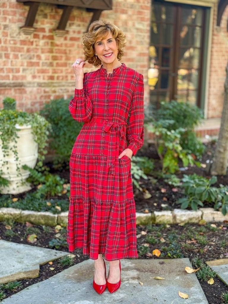 woman over 50 standing in front yard wearing UNTUCKit holiday plaid dress