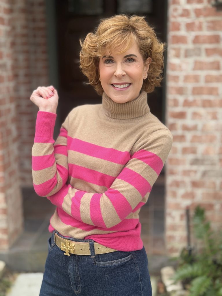 woman wearing cashmere turtleneck in mocha mousse shade with pink stripes