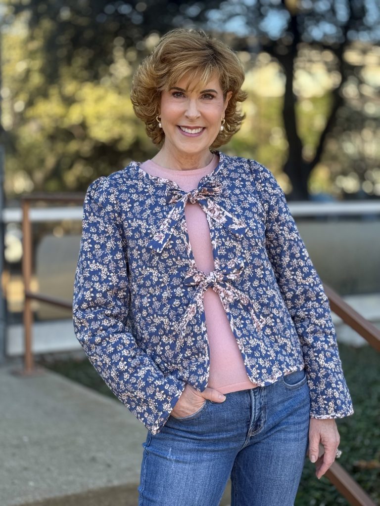 woman modeling a quilted jacket with bow ties