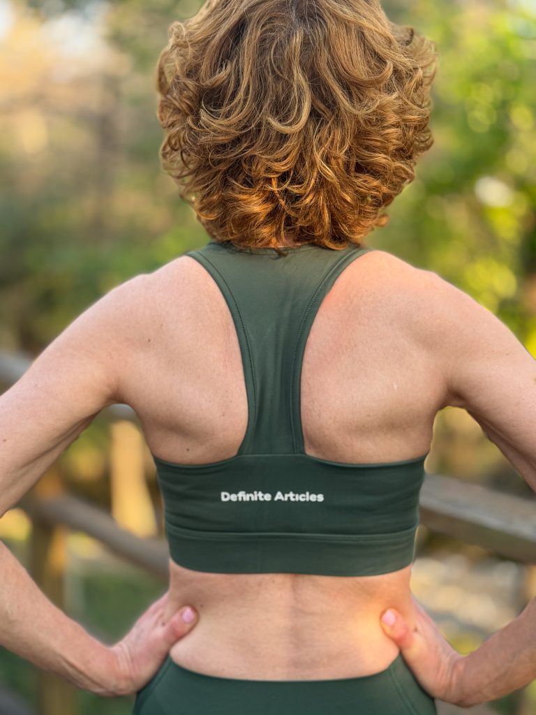 woman over 50 wearing definite articles sports bra pictured from the back