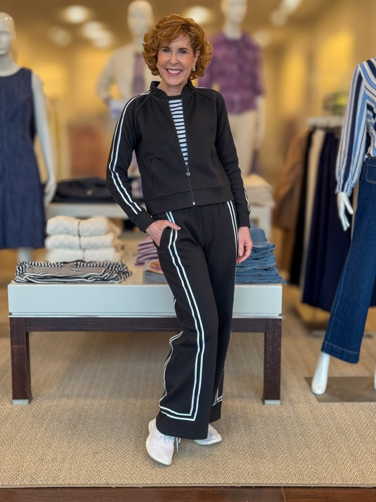 woman over 50 posing in a store wearing a two piece athleisure set