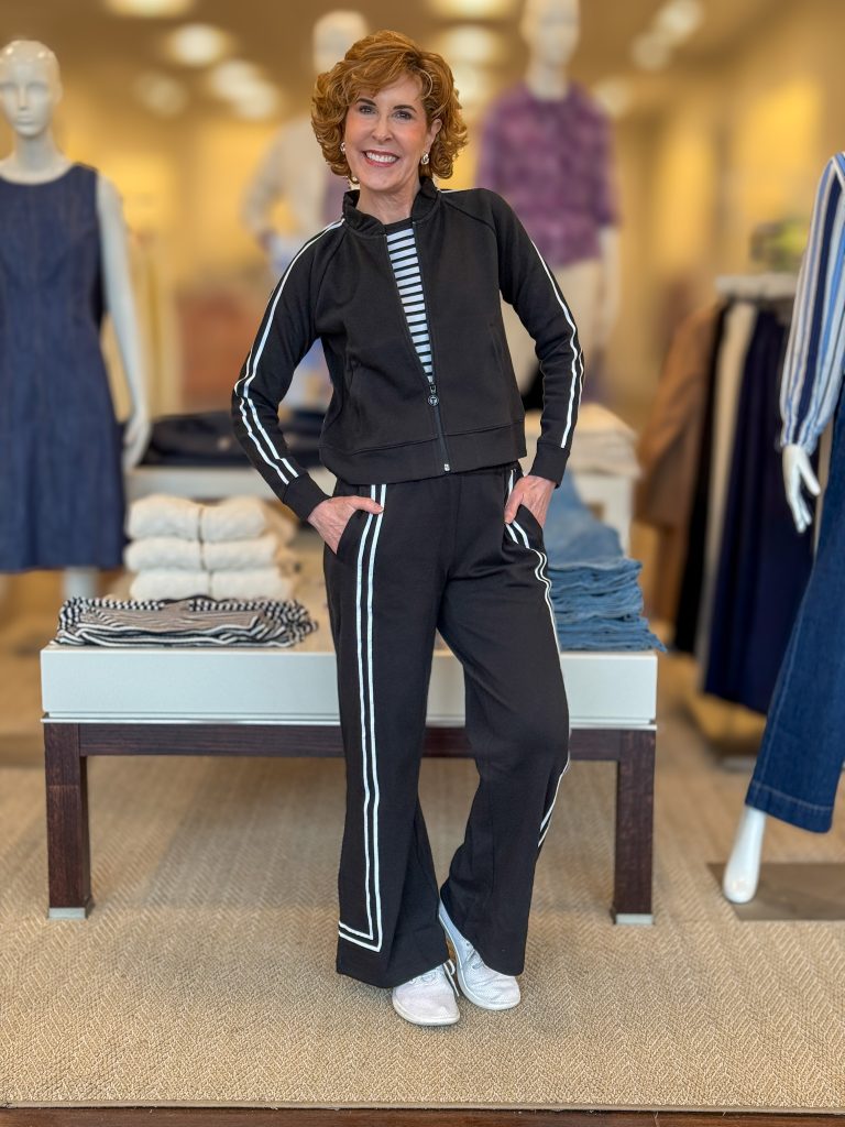 woman over 50 posing in a store wearing black and white two-piece set