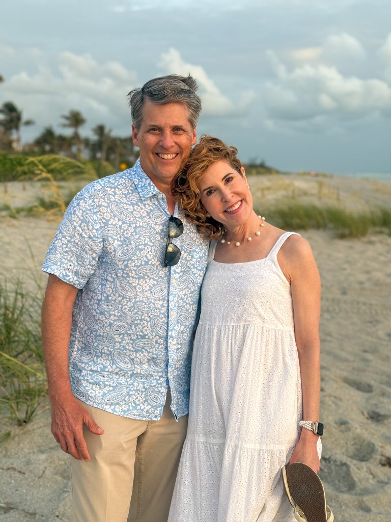 picture of a husband and wife standing on the beach